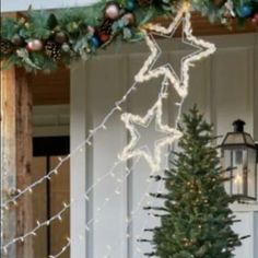 a decorated christmas tree in front of a white door with lights and decorations on it