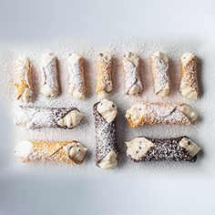 an assortment of pastries are arranged on a white surface