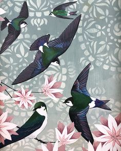 three birds are flying over pink flowers on a blue and white background with intricate designs