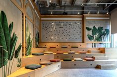 a room filled with lots of wooden steps and plants growing on the wall behind them