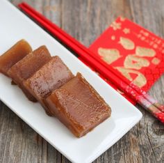 some food on a white plate with chopsticks and a red book in the background