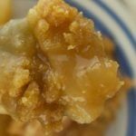 a close up of a piece of food on a blue and white plate with a fork