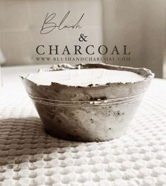 a close up of a bowl on a bed with the words bleach & charcoal