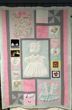 a baby quilt is hanging on the wall