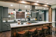 a kitchen with wooden floors and gray cabinets