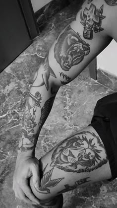 a man with tattoos on his arm and leg