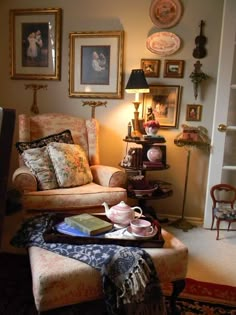 a living room filled with furniture and pictures on the wall