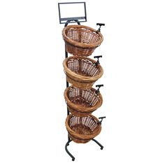 three wicker baskets on a metal stand