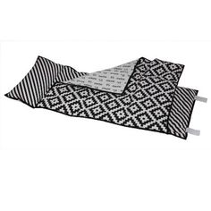 two black and white rugs sitting on top of each other