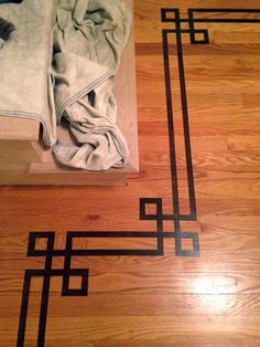 a wooden floor with black and white designs on it