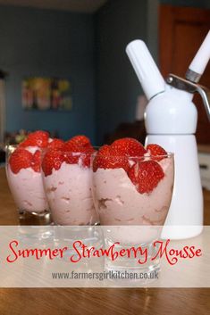 strawberry mousse with whipped cream and strawberries in small glasses on the counter