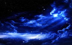 the night sky is full of stars and clouds, as well as some bright blue hues