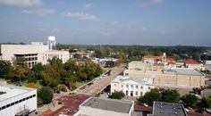 an aerial view of a city with buildings and trees