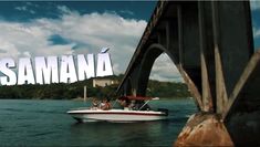 a boat traveling under a bridge with the word samana on it