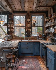 a rustic kitchen with blue cabinets and wood flooring is seen in this image from the inside