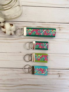 three keychains with different designs on them