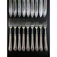 an assortment of silverplated knives and forks