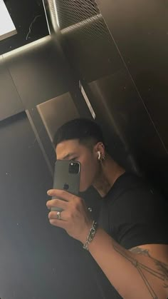 a man taking a selfie in a mirror with his cell phone up to his ear