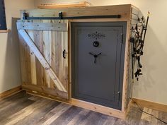 a large metal and wood safe in the corner of a room