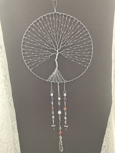 a metal fan with beads hanging from it's side