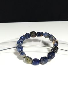 Natural  luxury Crysta  Sodalite Bracelet, Elastic Bracelet,  ,  high quality ,  perfect gift for women - men You will receive exactly the same Bracelet as you see in the pictures unique   will be shipped free with security number Size         : 9 -11 mm  beads Length    : 8 inches , 20 cm Weight   : 42 grams . [specific weight] Amazing original handmade luxury bracelet, unique in the construction of genuine  Sodalite  ,Ideal for gifts of high quality and energy  The Sodalite crystal acts as a " Blue Sodalite Bracelets For Gift, Spiritual Sapphire Hand-strung Beaded Bracelets, Blue Sodalite Jewelry, Hand-strung Blue Sodalite Bracelet, Casual Hand-strung Blue Crystal Bracelet, Sodalite Crystal, Luxury Bracelet, Elastic Bracelet, High Quality