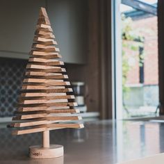 a wooden christmas tree sitting on top of a counter