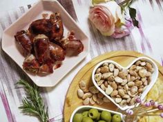 some food is sitting on a table with flowers and other things to eat for dinner