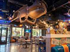 the inside of a restaurant with lots of tables and chairs