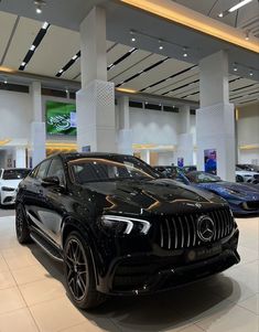 several cars are on display in a showroom