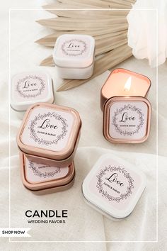 three candles are sitting next to each other on a white tablecloth with palm leaves