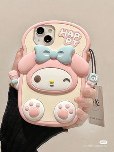 a person holding up a cell phone case with a hello kitty design on the back