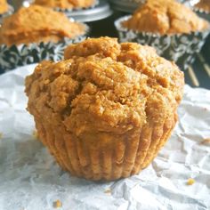 a muffin sitting on top of a piece of paper next to other muffins