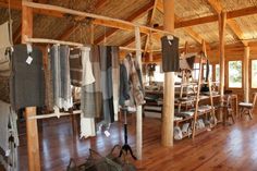 a room with wooden floors and walls filled with clothes