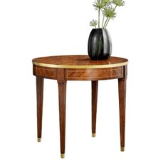 a table with a vase on top of it and a plant in the middle, against a white background