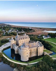 an aerial view of a castle near the ocean