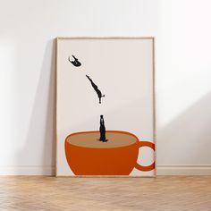 an orange coffee cup with a person falling into it, in front of a white wall