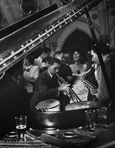 black and white photograph of people playing musical instruments