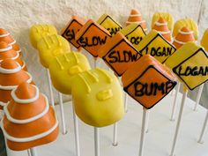 there are many road signs on sticks with candy in the shape of cones and traffic signs