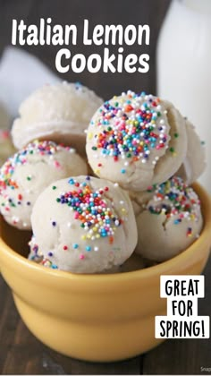 a bowl full of italian lemon cookies with sprinkles and milk in the background