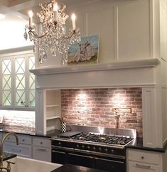 a kitchen with a chandelier hanging from the ceiling