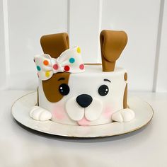 a cake decorated with a dog's head and ears on top of a plate