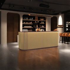 an empty bar with stools and bottles on the shelves