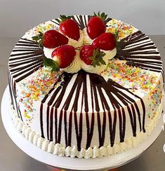 a white cake with chocolate and strawberries on top