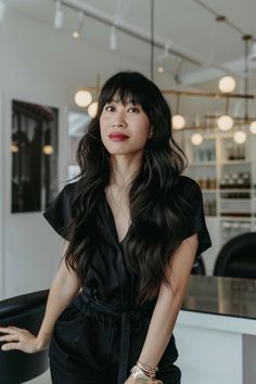 Woman with long hair styled in wavy layers and bangs. Wavy Layers With Bangs, Layers With Bangs Long Hair, Layers With Bangs, Bangs Long Hair, Wavy Layers