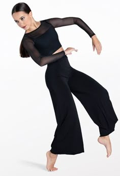 a woman in black is dancing on a white background