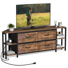 a flat screen tv sitting on top of a wooden dresser