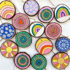 a group of wooden slices with different designs on them, all painted in different colors