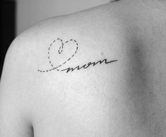 a woman's back shoulder with the word mom written in cursive writing