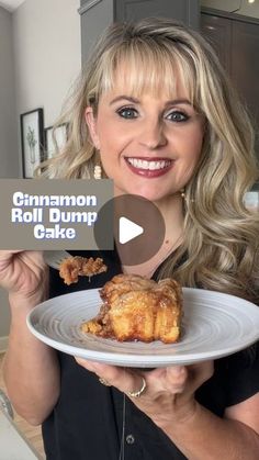 a woman holding a white plate with food on it and the words cinnamon roll dump cake