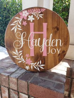 a wooden sign with the letter h painted on it